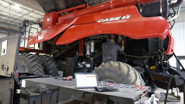 Service Technician performing Uptime on a combine
