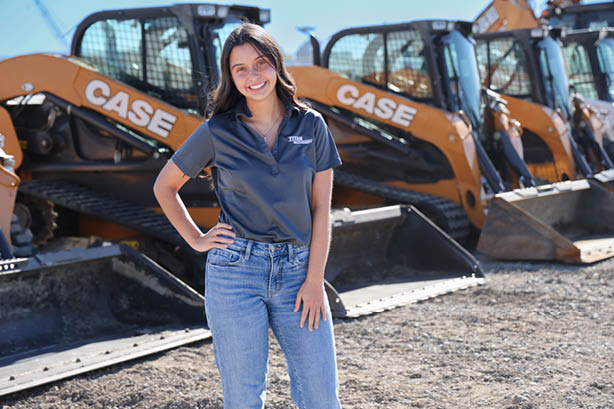 Business of Sales Intern Standing by Equipment