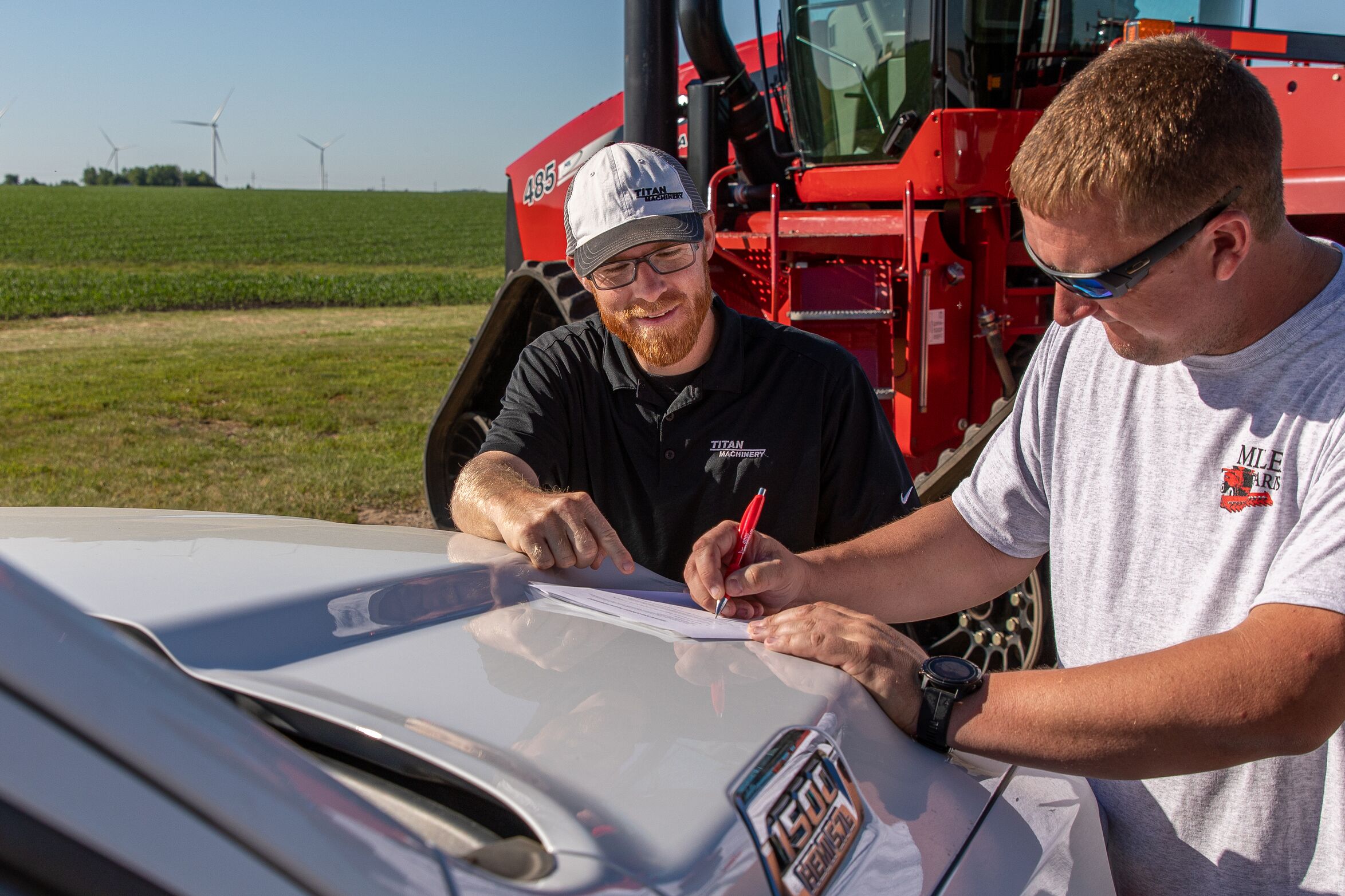 Salesman and customer signing paperwork